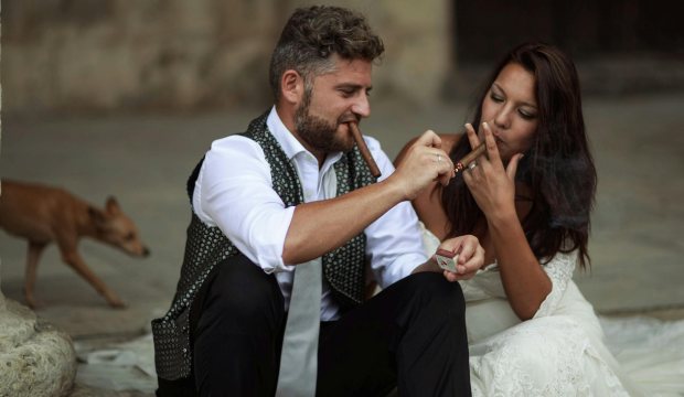 man and woman smoking cigar together